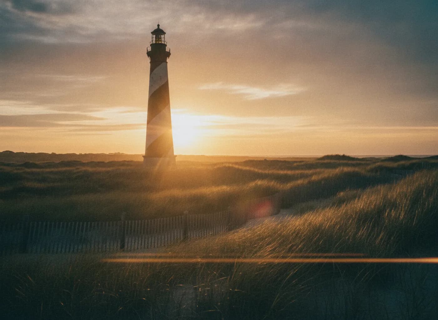 Filming location Absecon Lighthouse above coastal dune grass at golden hour