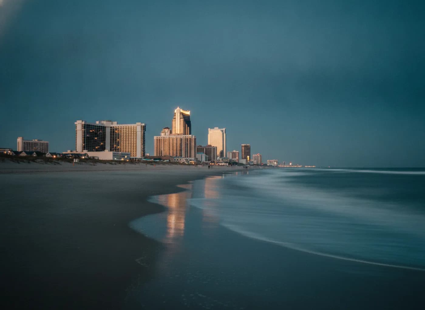 Atlantic City casino skyline at blue hour seen from the beach