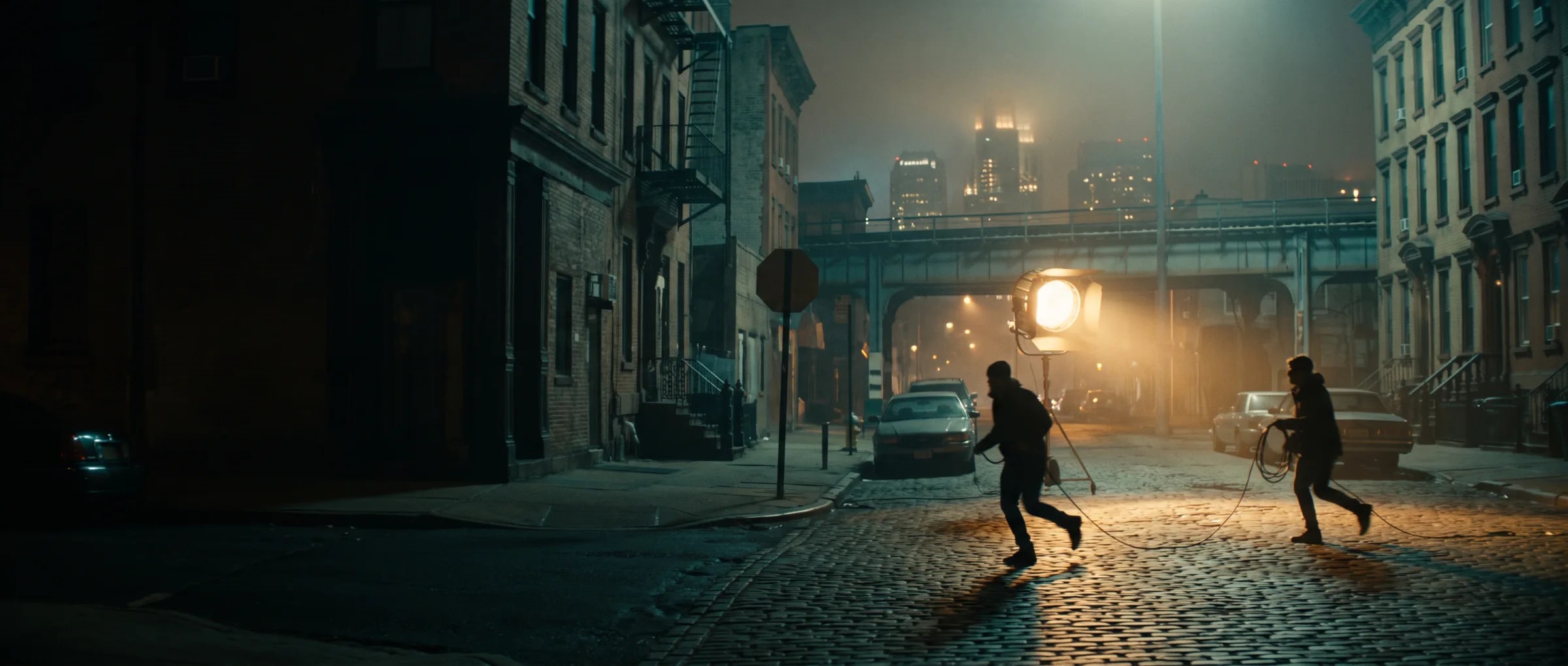Filming location Newark New Jersey — night shoot on a brownstone street with the downtown skyline behind