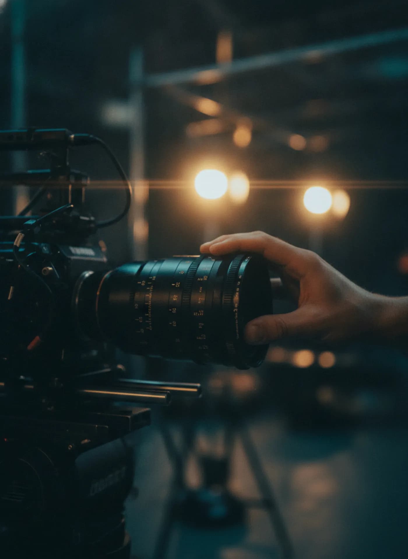 An apprentice pulling focus on a cinema camera lens during a Lion Motion production